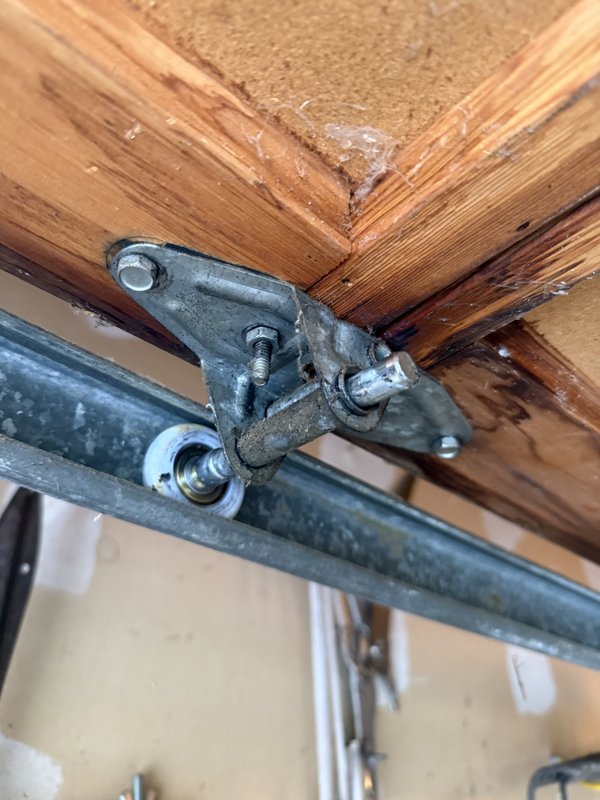 Fresh garage door roller and hinge hardware after service